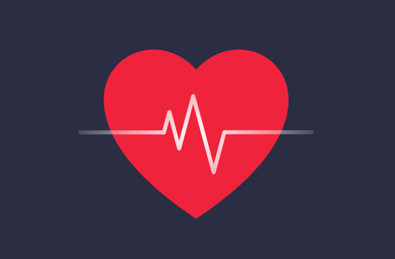 Red heart shape and heartbeat symbol, cardiogram, health care concept. Blue background.